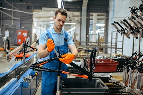 bicycle,factory,,worker,holds,teen,bike,frame