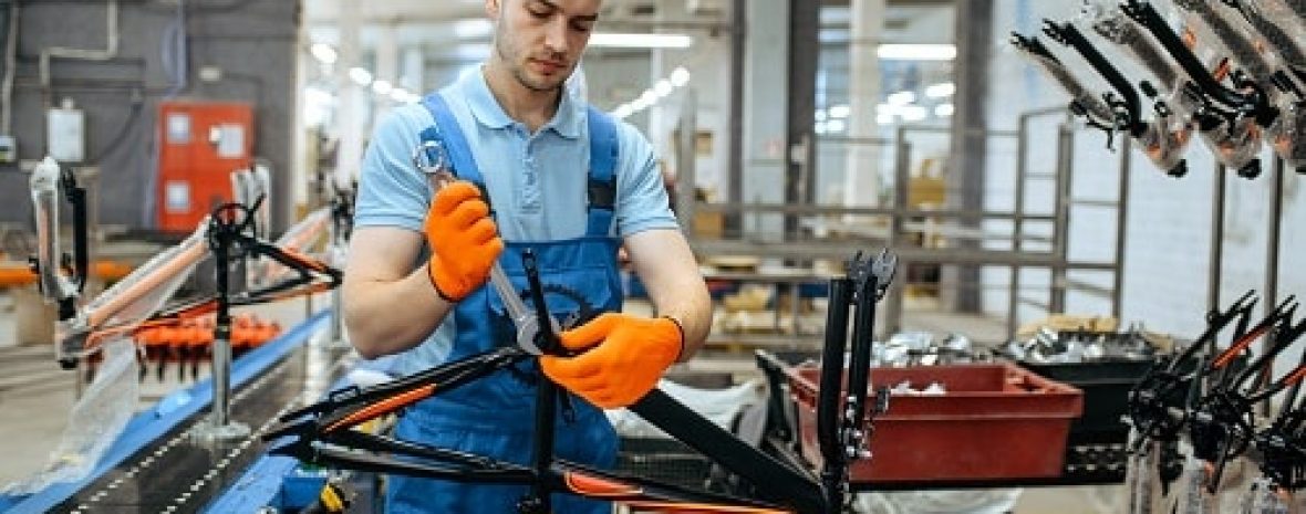 bicycle,factory,,worker,holds,teen,bike,frame